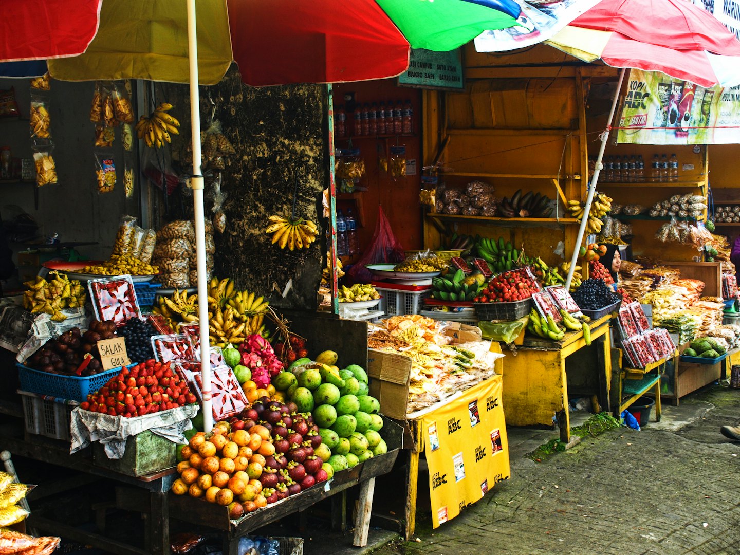 Fresh fruits and snacks displayed at an outdoor market stall.
